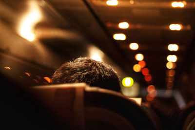 Rear view of man seen through car windshield