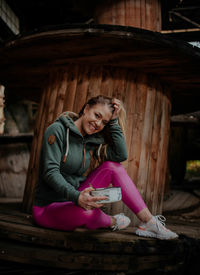 Portrait of a smiling young woman sitting outdoors