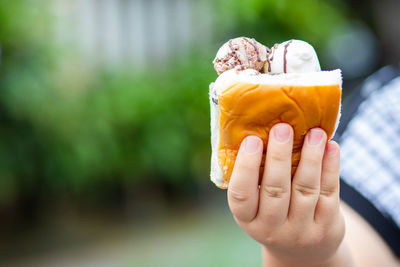 Close-up of hand holding ice cream