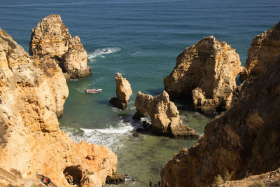 High angle view of rocks on sea shore