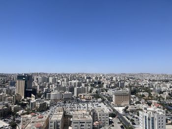 Cityscape against clear blue sky