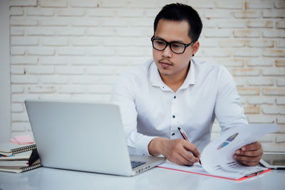 Young man using laptop on table