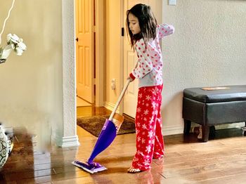 Full length of girl standing on floor at home