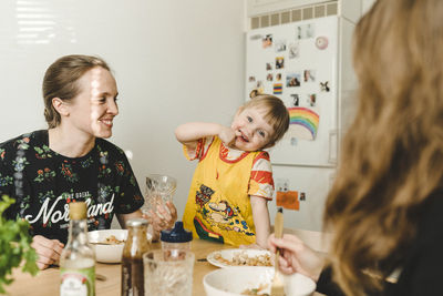 Mother with daughter sitting at table