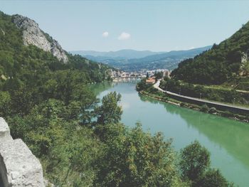 High angle view of river amidst trees against sky