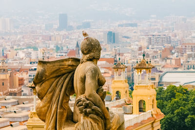 Beautiful statue against the panoramic city view form the national museum of catalan 