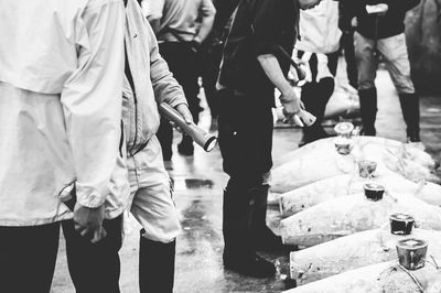 Low section of people standing on street