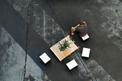 High angle view of man sitting on chair