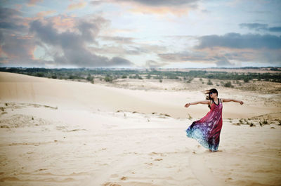 Rear view of woman standing on landscape