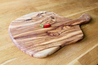 High angle view of red chili pepper on cutting board