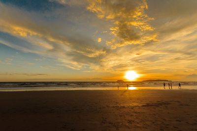 Scenic view of beach against sky during sunset