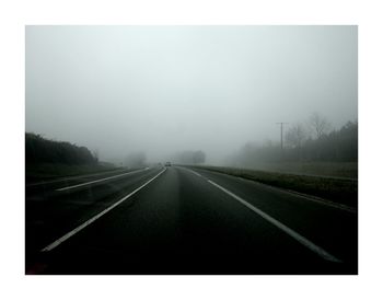 Road passing through foggy weather