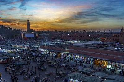 High angle view of illuminated cityscape against sky during sunset