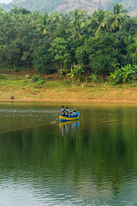 Boat in lake against trees