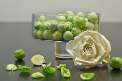 Cabbages and paper flower on table