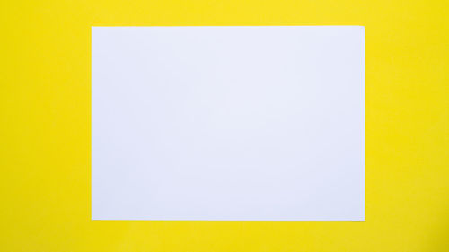 Close-up of yellow paper against blue background