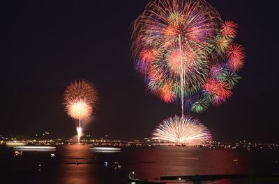 Sea against firework display at night