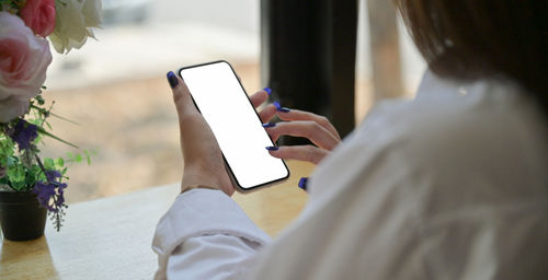 Midsection of woman using mobile phone