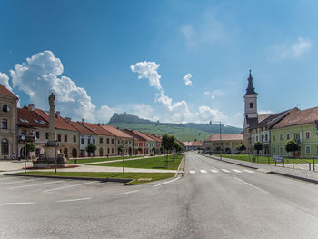 Road amidst buildings against sky in city