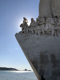 Low angle view of statue against sea