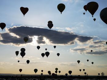 Low angle view of hot air balloons flying in sky