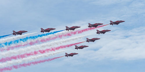 Low angle view of airshow against sky