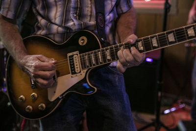 Close-up of guitar playing guitar