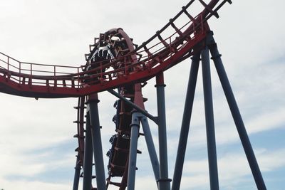 Low angle view of amusement park ride against sky