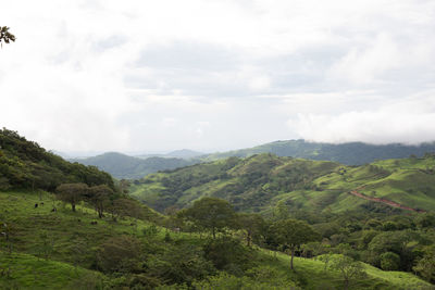 Scenic view of mountains against cloudy sky