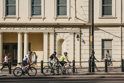 Bicycles on street against building in city