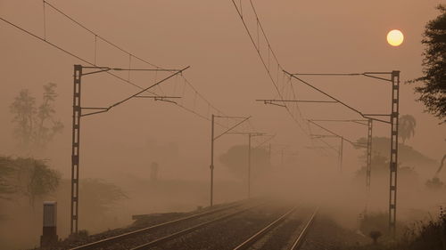 Railroad tracks taken in heavy fog and sunrise near manjari budruk railway station.