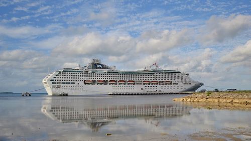 Panoramic view of ship moored on sea against sky