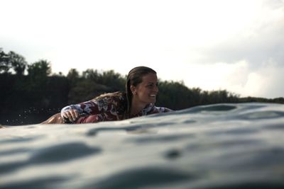 Woman surfing on sea