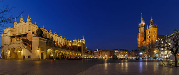 Illuminated cathedral against blue sky at night