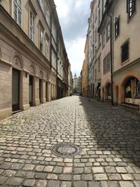 Cobblestone street amidst buildings in town