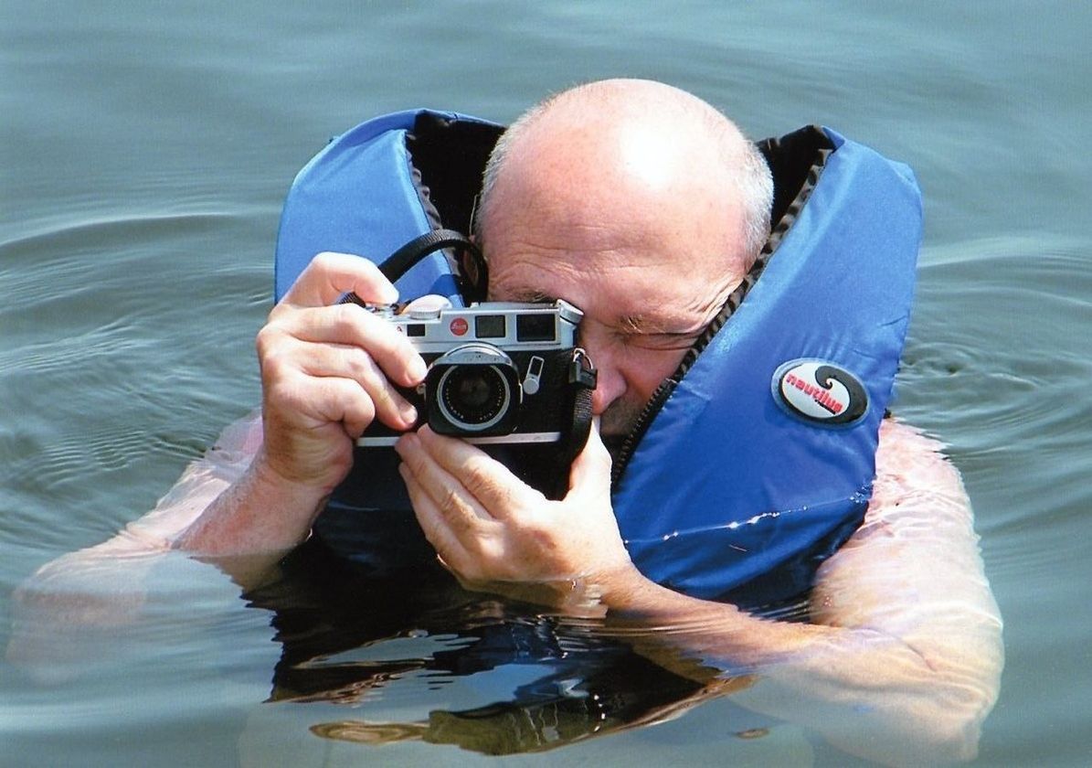 CLOSE-UP PORTRAIT OF PERSON PHOTOGRAPHING IN LAKE