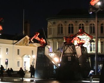 Statue in town square at night