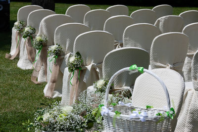 Close-up of basket and chairs arranging at event in sunny day