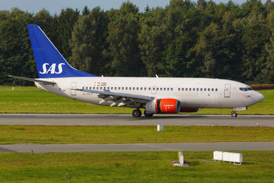 Side view of airplane on runway