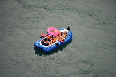 High angle view of father with son sitting on beach