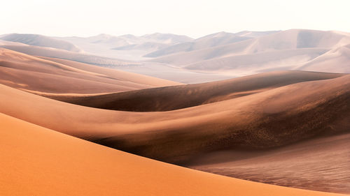 Nature and landscapes of dasht e lut or sahara desert with sand dunes in foreground and hazy sky