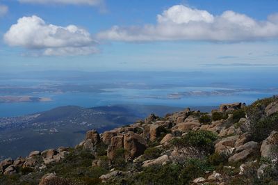 Scenic view of sea and mountains against sky