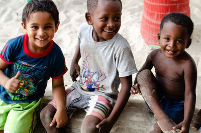 Portrait of happy friends sitting outdoors