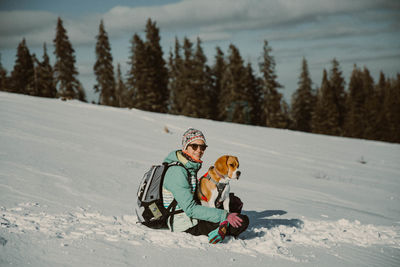 Boy playing with snow on mountain