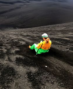 High angle view of mature woman sitting on mountain