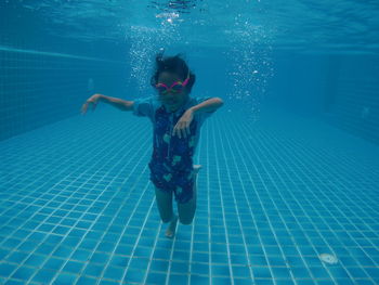 Full length of girl swimming in pool