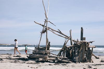 Lifeguard hut on beach against sky