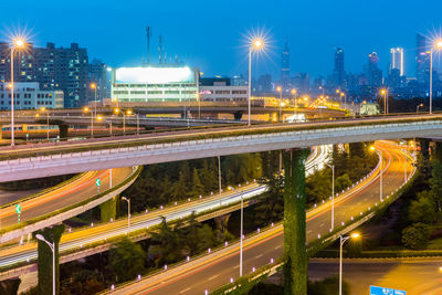 Light trails on bridge in city at night