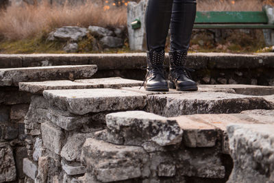 Low section of man standing on retaining wall