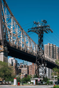 Low angle view of crane bridge against clear blue sky